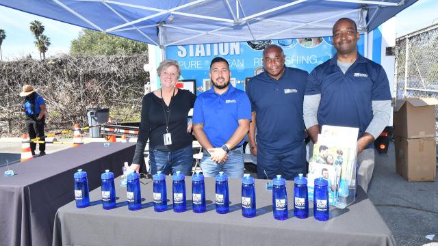 four ladwp employees in an LADWP booth at an event