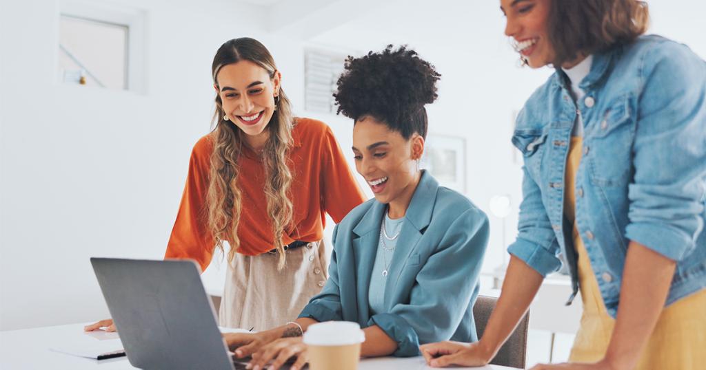 three ladies collaborating on a laptop