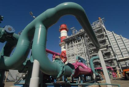 View from ground towards steam stack and cooling pipes