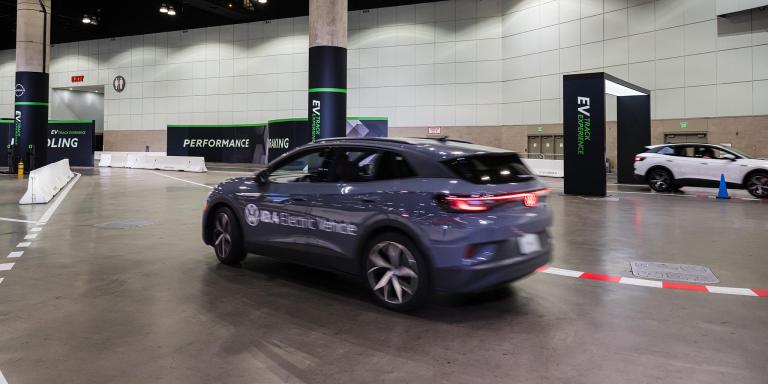 a blue EV at an auto show