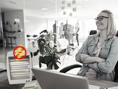 woman sitting at desk with space heater
