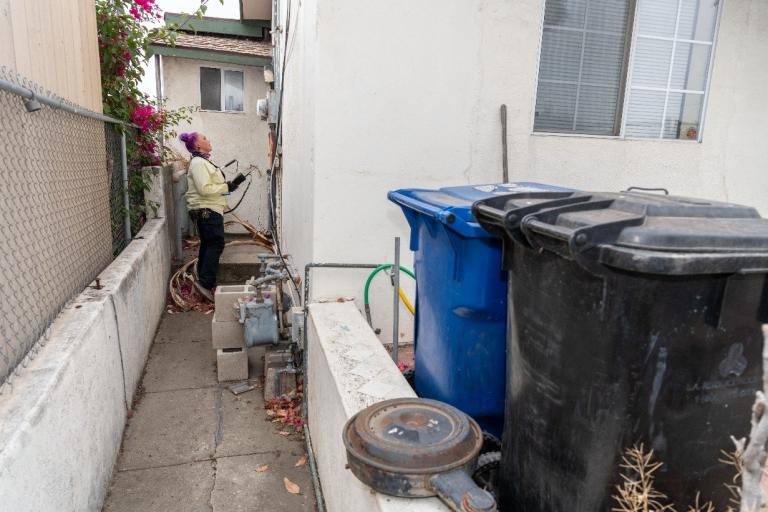 LADWP field employee looking at meter on house