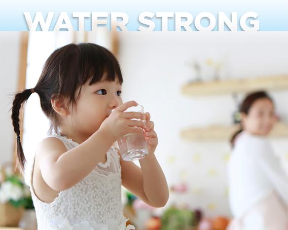 girl holding glass of water