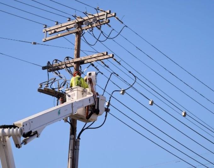 Crew member is outside working on power restoration.