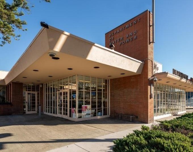 Building with a sign that says, “Department of Water and Power” and a grassy lawn in front. 