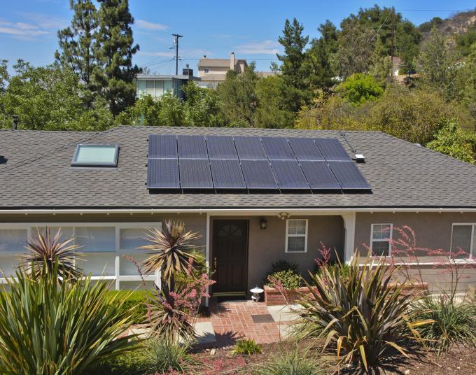 Aerial shot of single family home with solar panel array. 