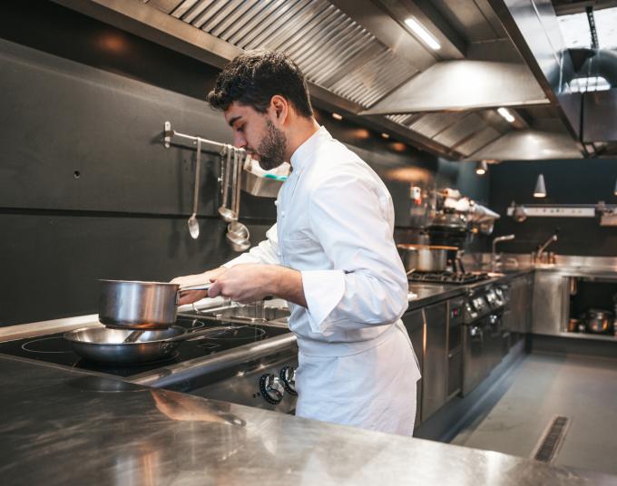 man cooking over cooktop