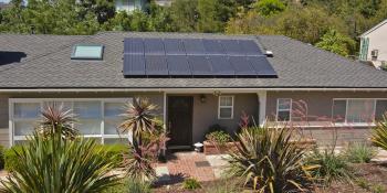 Aerial shot of single family home with solar panel array. 