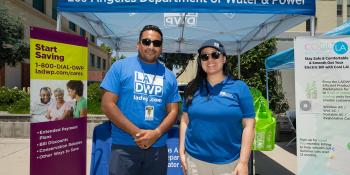 Two  persons standing in front of an LADWP booth